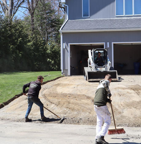 John Cooper Asphalt Paving Employees Sweeping Up the Driveway to Be Paved in Rhode Island