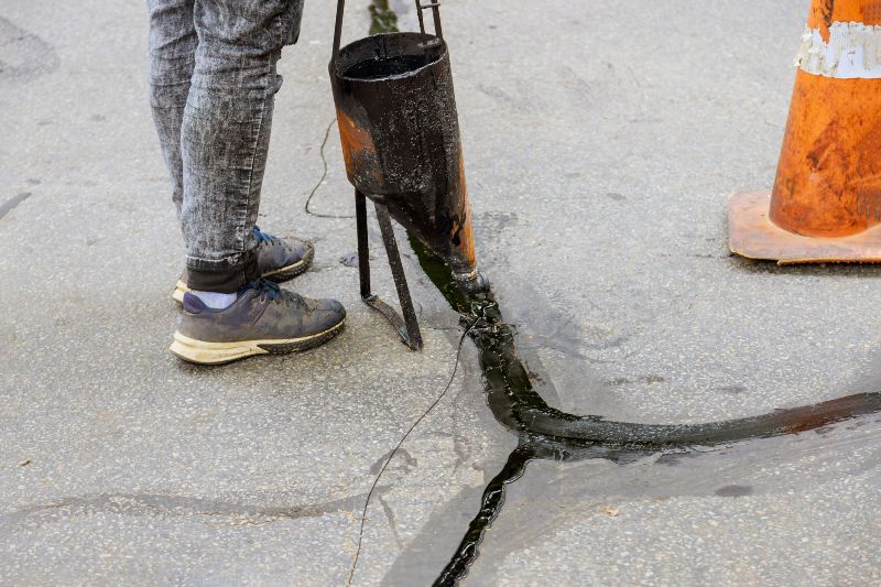 Crack Sealing Process on a Residential Asphalt Driveway in Cranston, RI & Nearby Areas