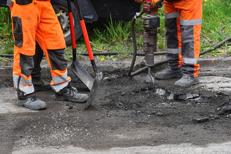 Professional Workers Patching Asphalt Surface for Driveway Repair in Cranston, RI & Nearby Areas